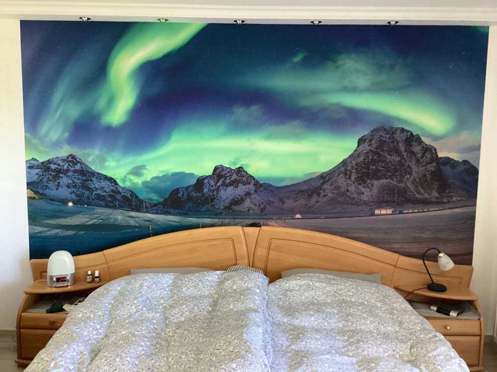 Northern lights above snowy mountains