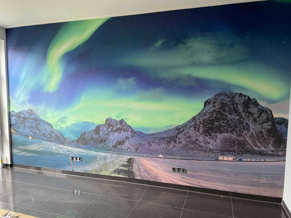 Northern lights above snowy mountains