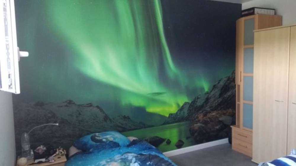 Northern lights between two fjords