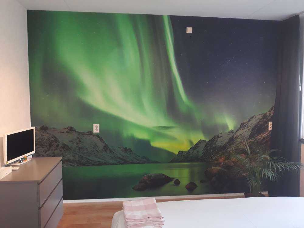 Northern lights between two fjords