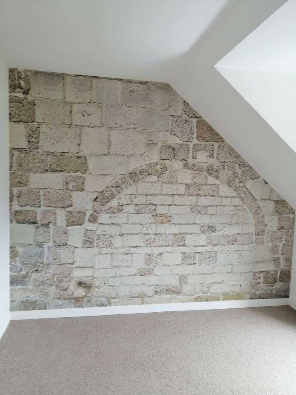 Old stone wall with arch