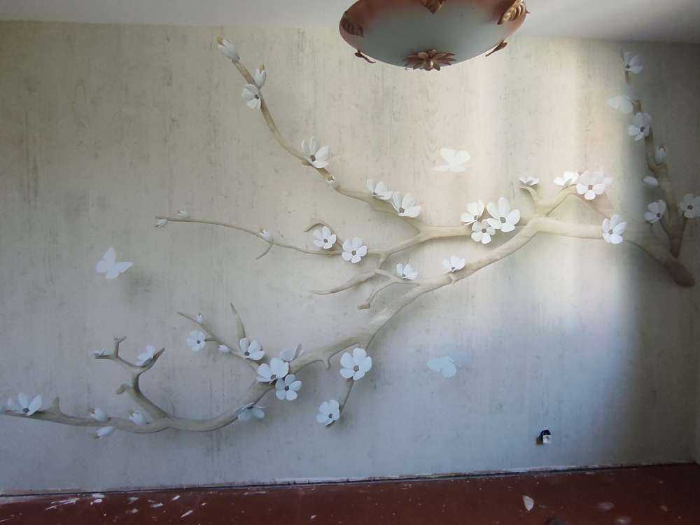 Branch with white flowers on wooden background