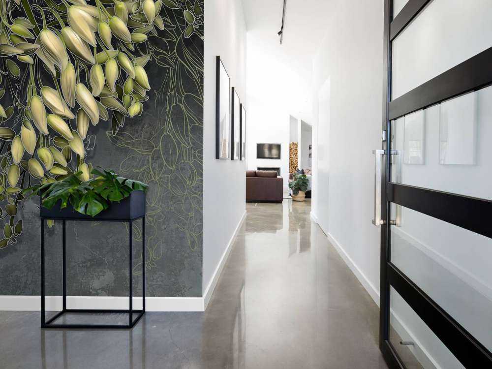 White flower calyxes on a dark gray concrete structure