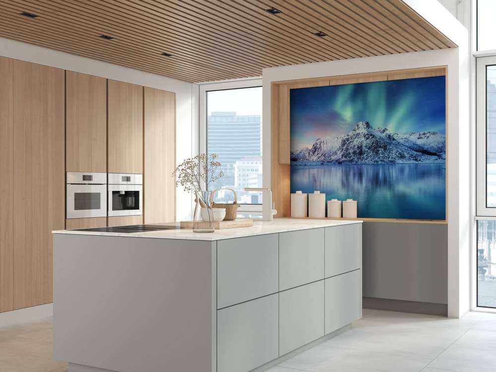 Northern lights over a frozen ocean and mountains