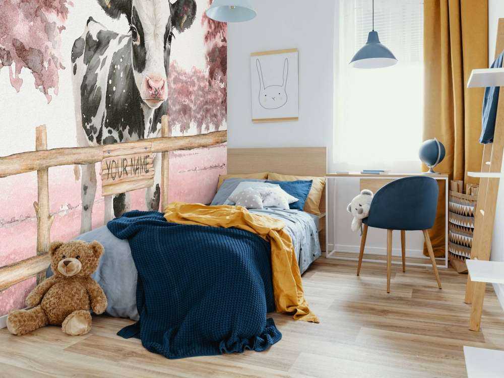 Young cow in a meadow pink