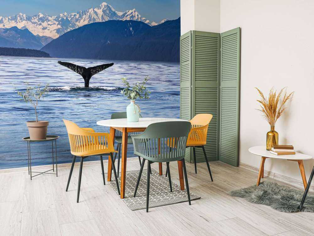 Diving whale with mountains in the background