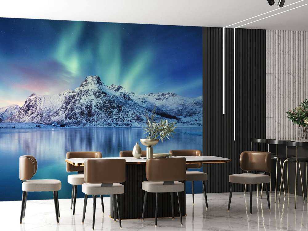 Northern lights over a frozen ocean and mountains