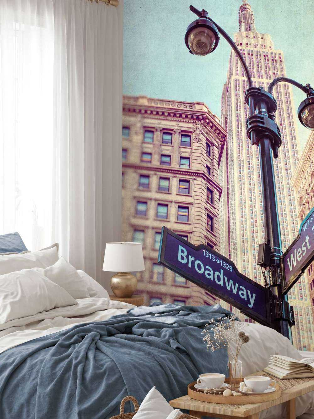 Street lamp and street signs with Empire State building in background - New York