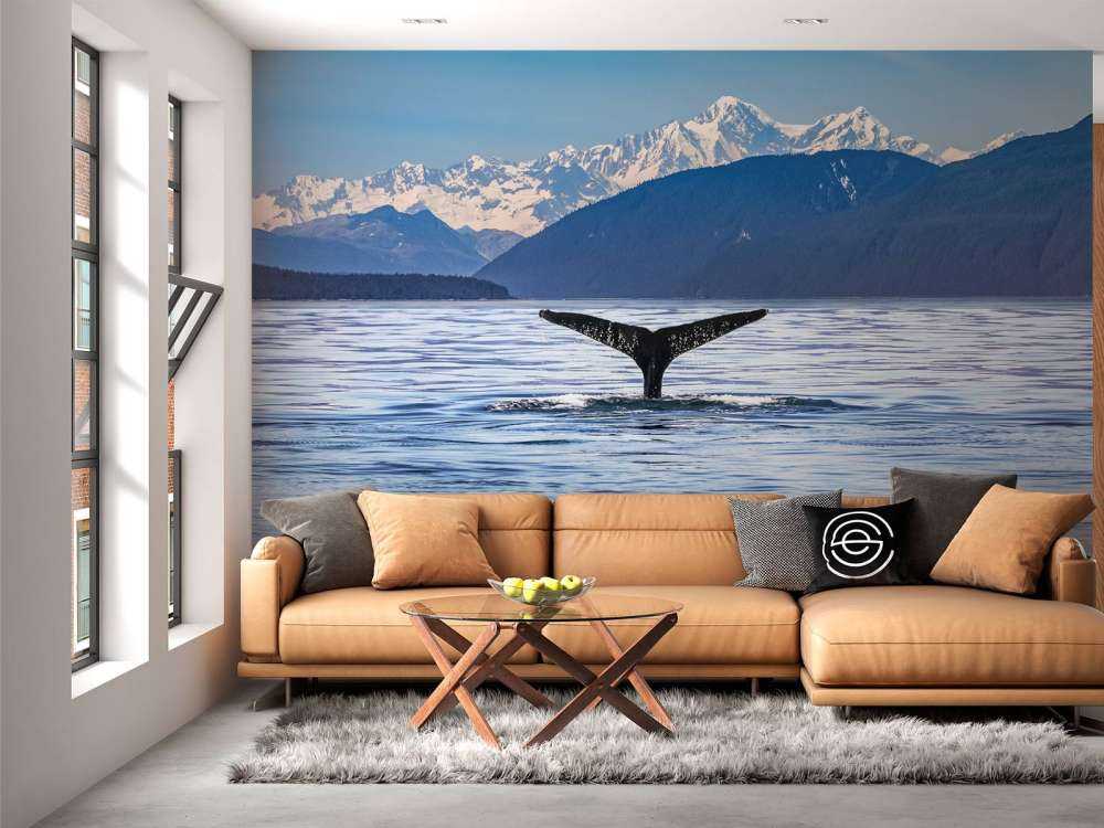 Diving whale with mountains in the background