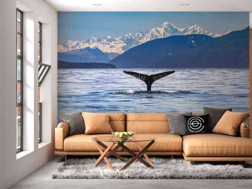 Diving whale with mountains in the background