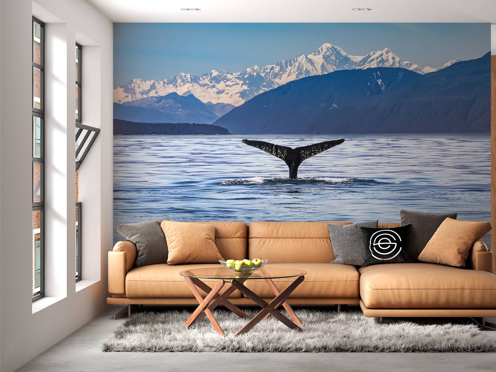 Diving whale with mountains in the background