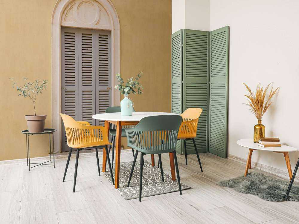 Window with wooden shutters on yellow wall