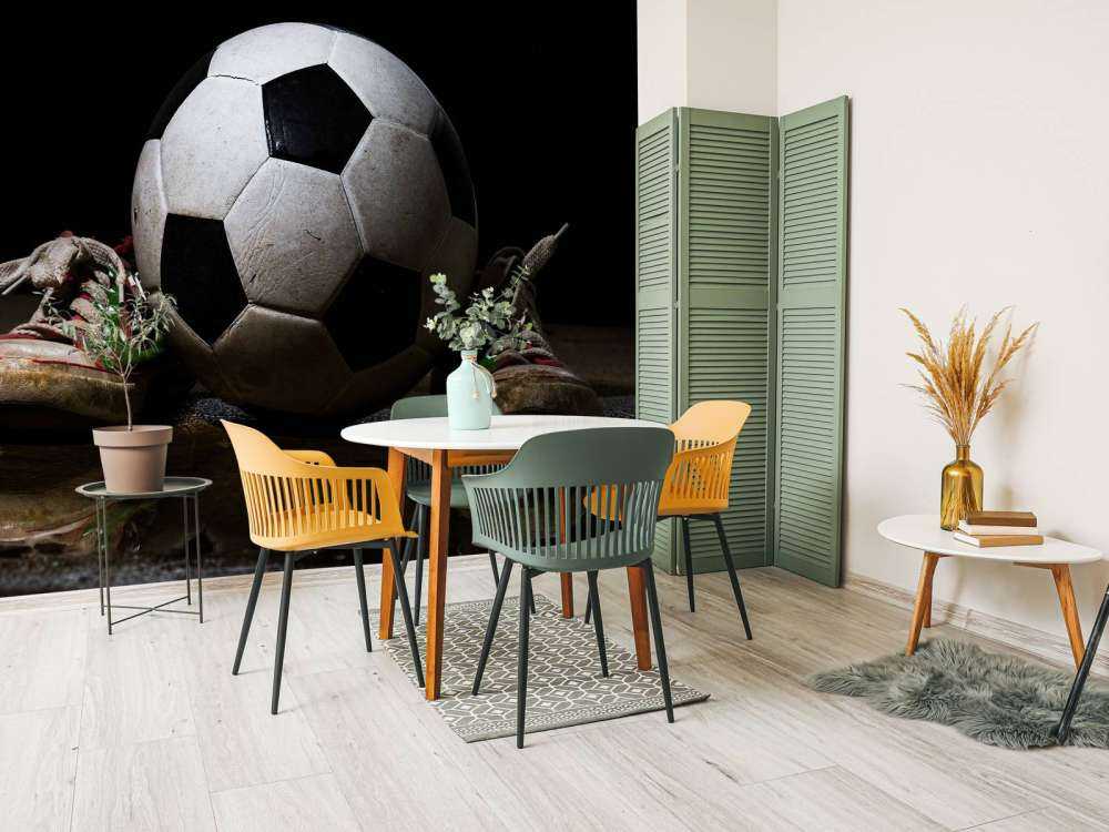 Football between two sneakers