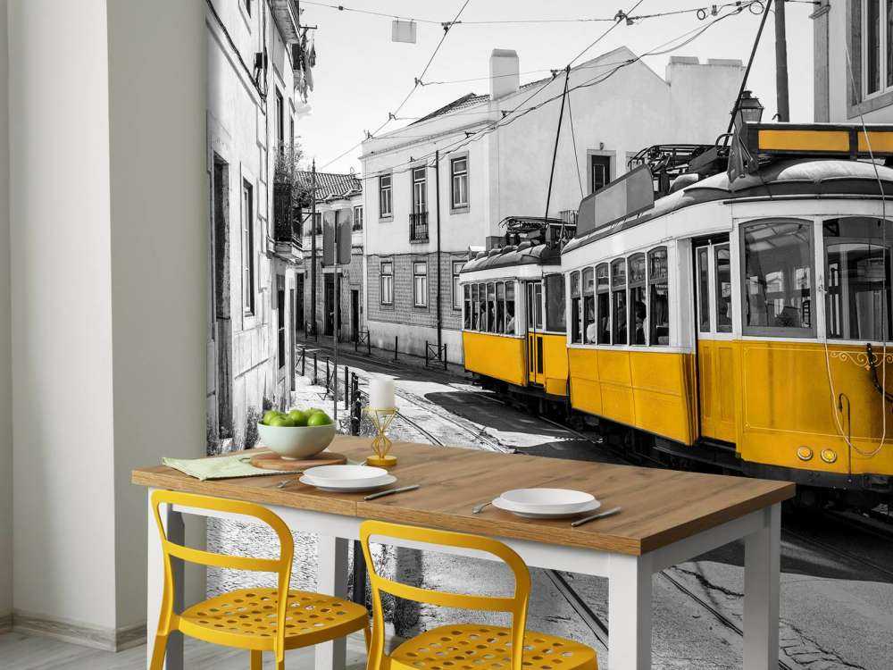 Yellow tram in a black and white street