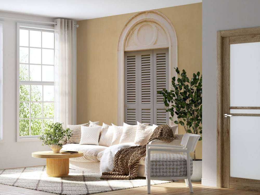 Window with wooden shutters on yellow wall
