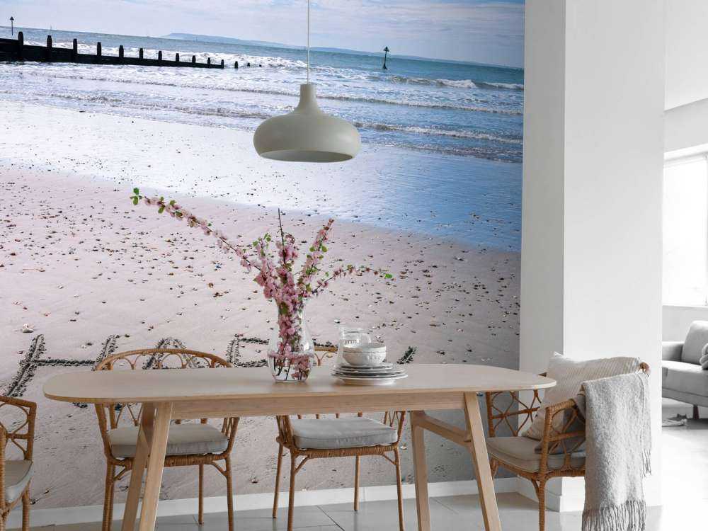 HAPPY message written in smooth sand at the beach