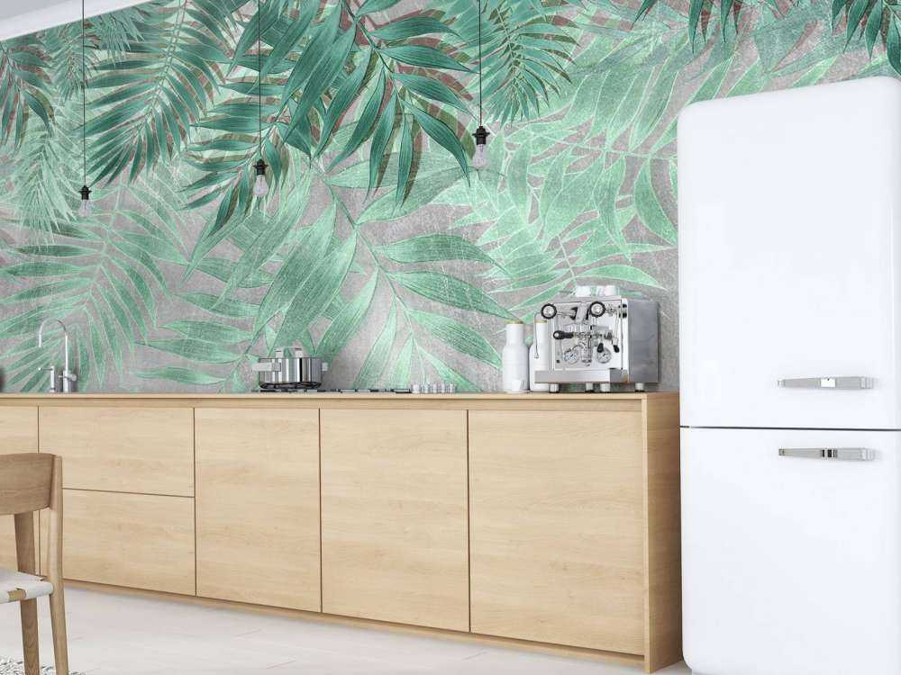 Green palm leaves with gray concrete wall