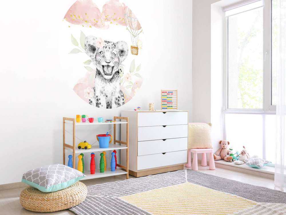 Joyful lion cub and balloon