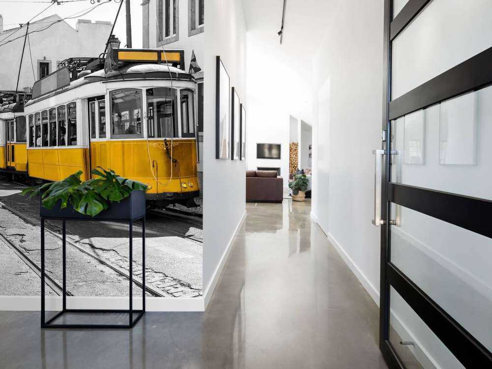 Yellow tram in a black and white street