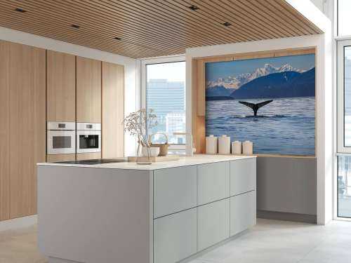 Diving whale with mountains in the background