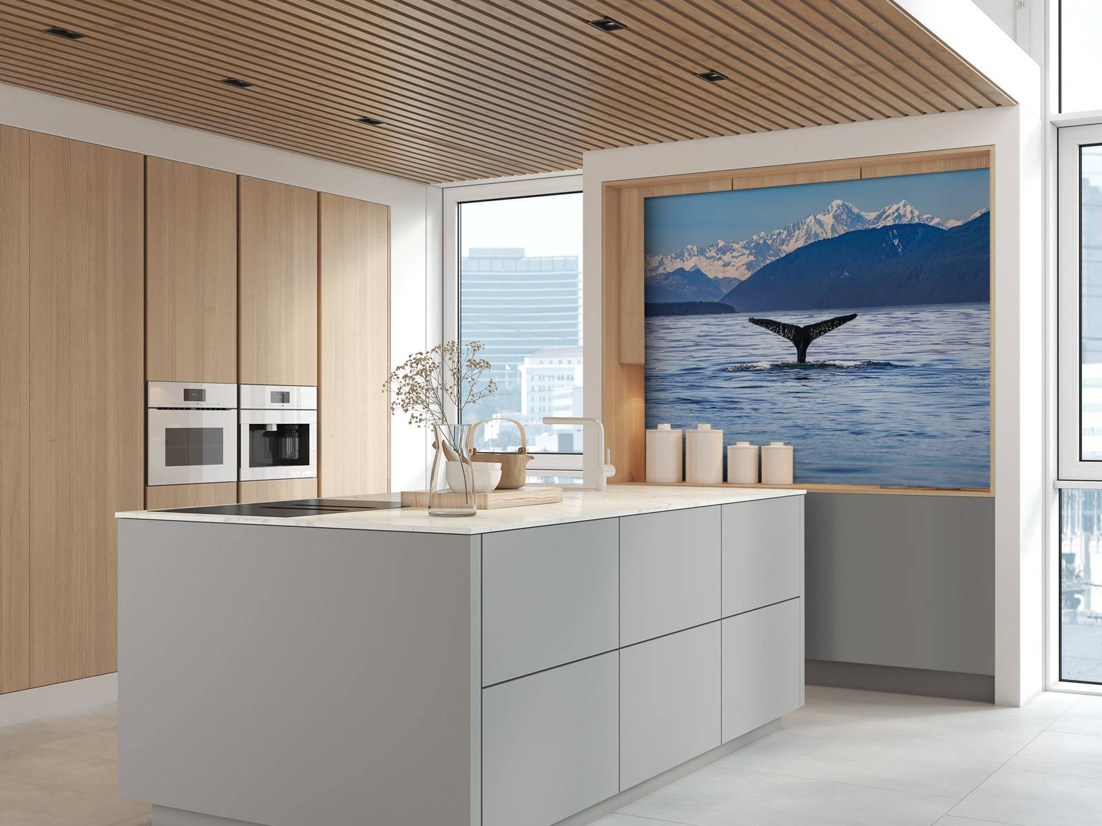 Diving whale with mountains in the background