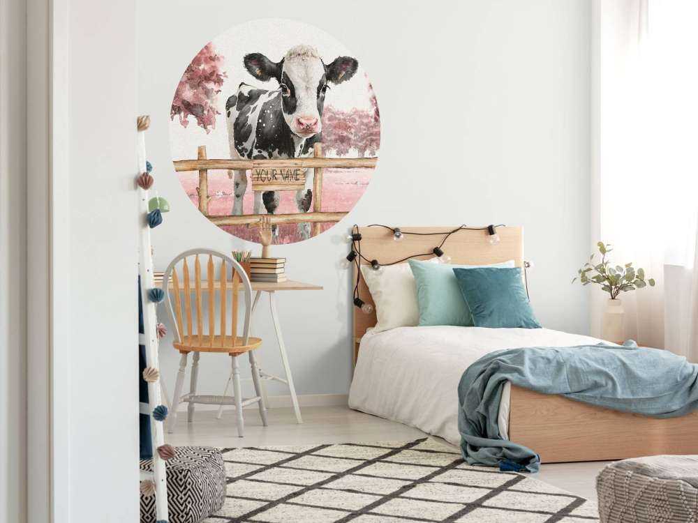 Young cow in a meadow pink