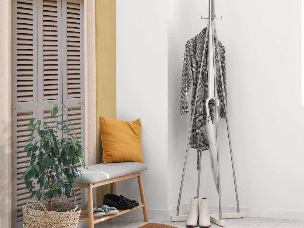 Window with wooden shutters on yellow wall