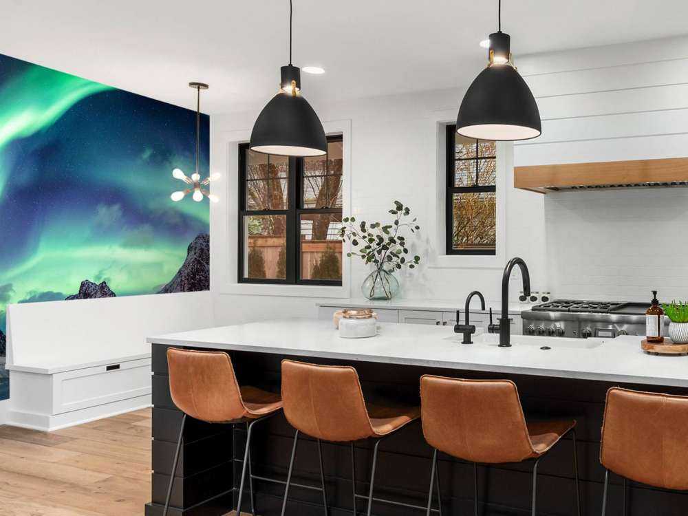 Northern lights above snowy mountains