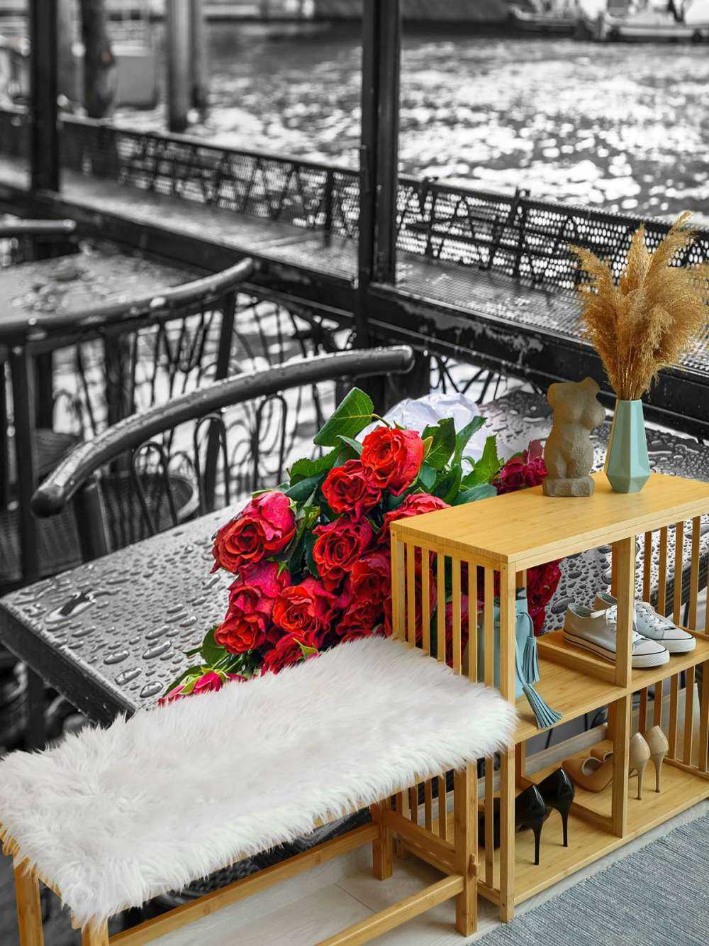 Bunch of red roses on street cafe table, Rialto Bridge, Venice, Italy