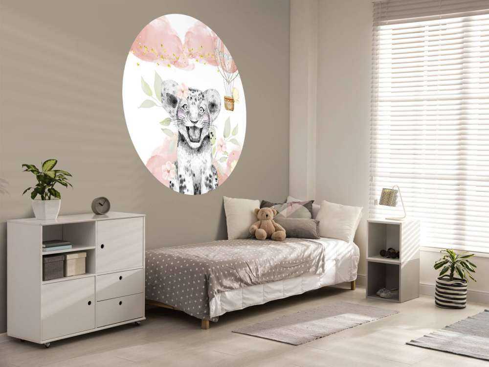 Joyful lion cub and balloon