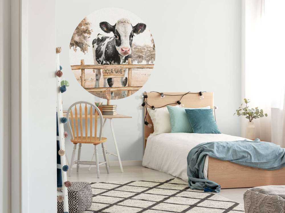 Young cow in a meadow taupe
