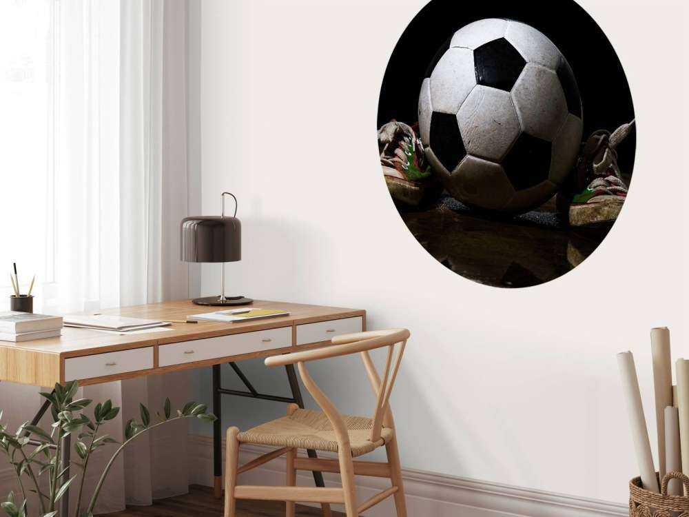 Football between two sneakers