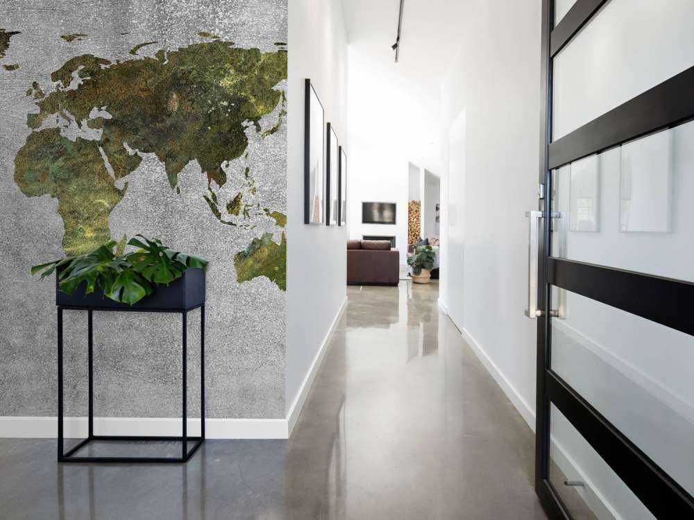 World map with green structure on grey concrete