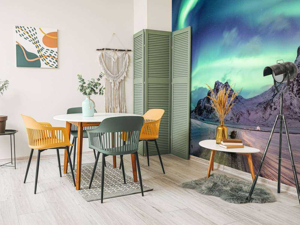 Northern lights above snowy mountains