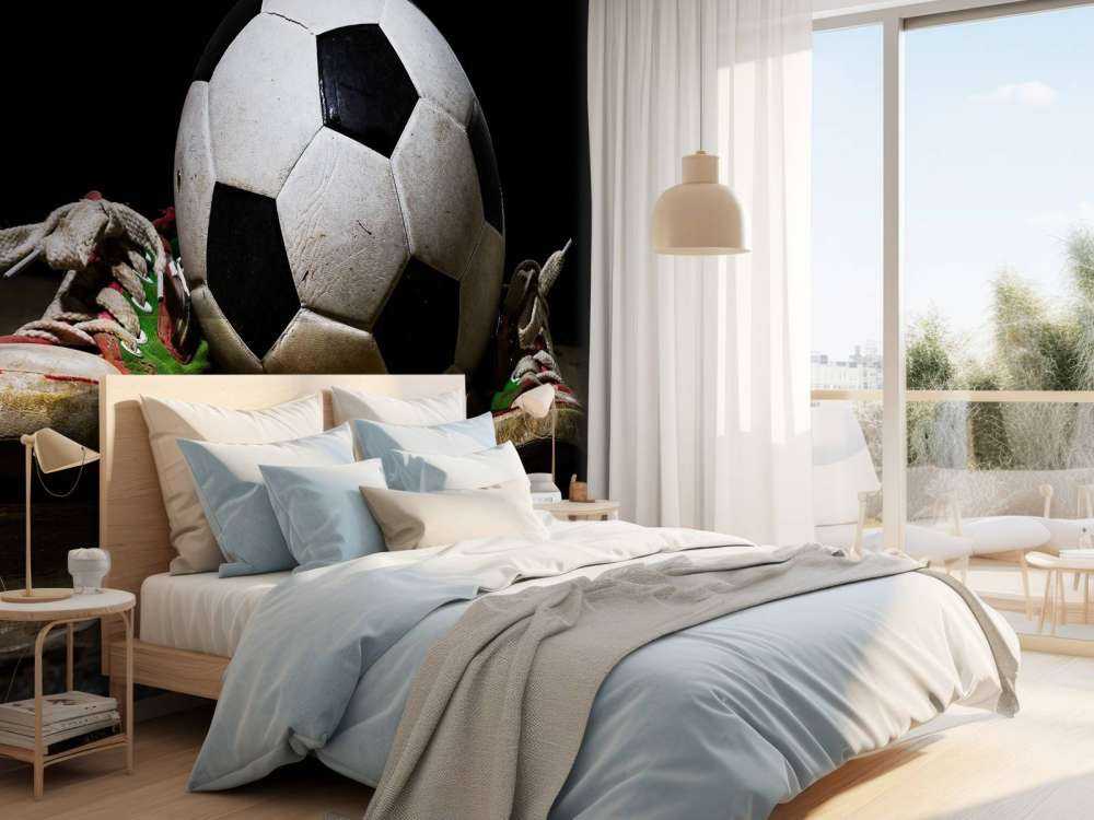 Football between two sneakers