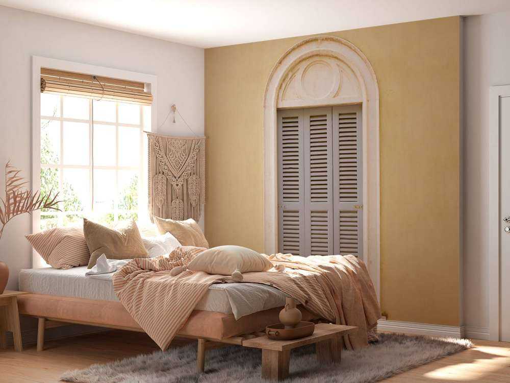 Window with wooden shutters on yellow wall