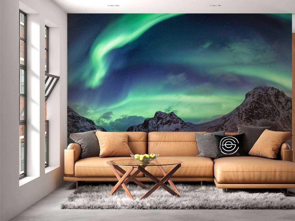 Northern lights above snowy mountains