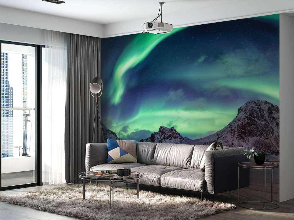 Northern lights above snowy mountains