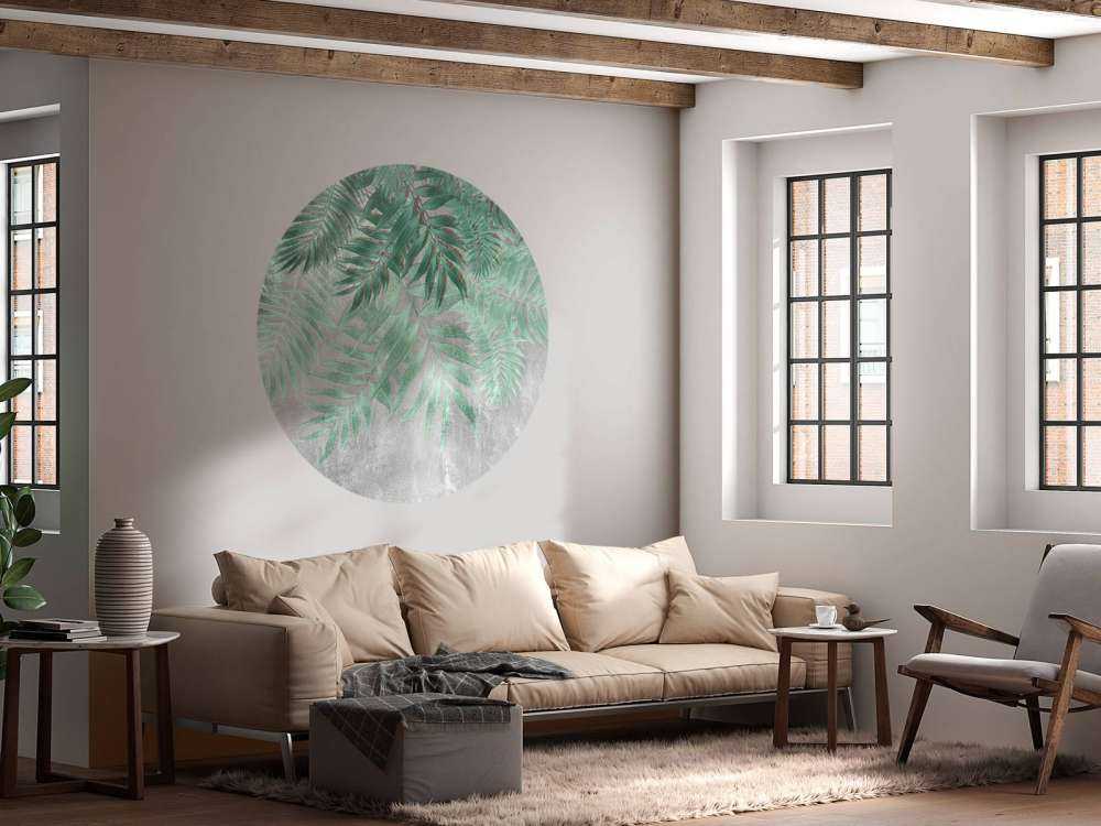 Green palm leaves with gray concrete wall