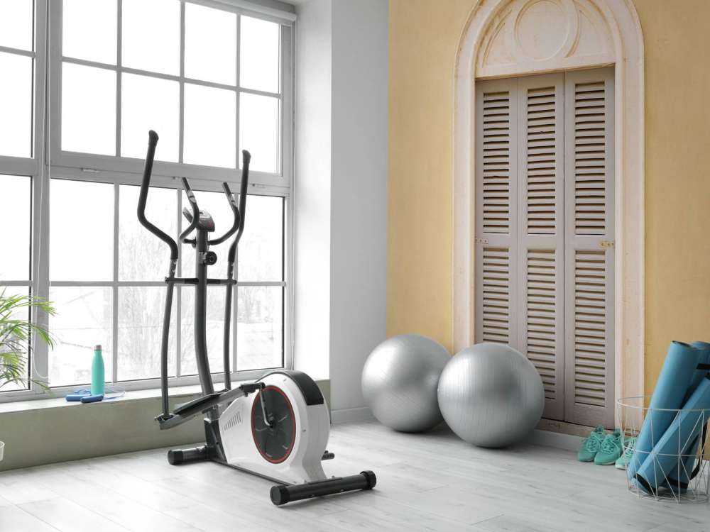 Window with wooden shutters on yellow wall