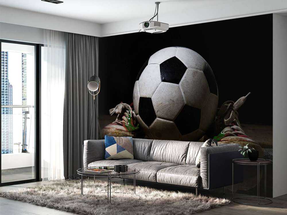 Football between two sneakers