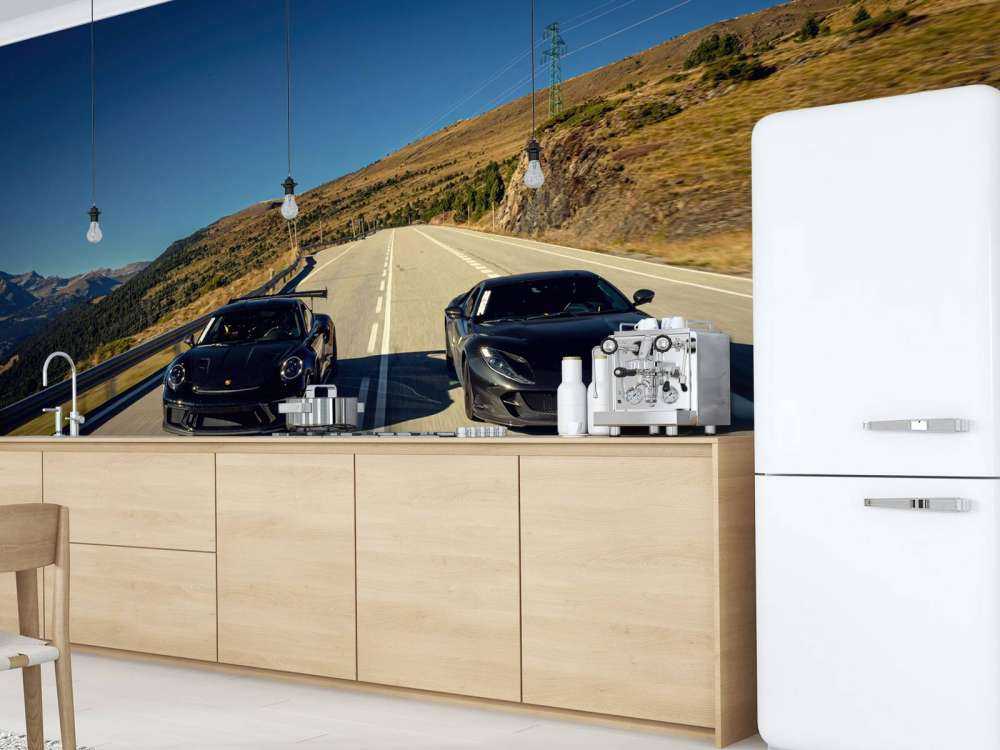 Black supercars in the mountains