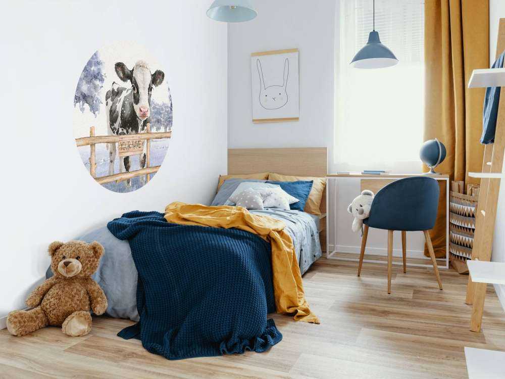 Young cow in a meadow blue