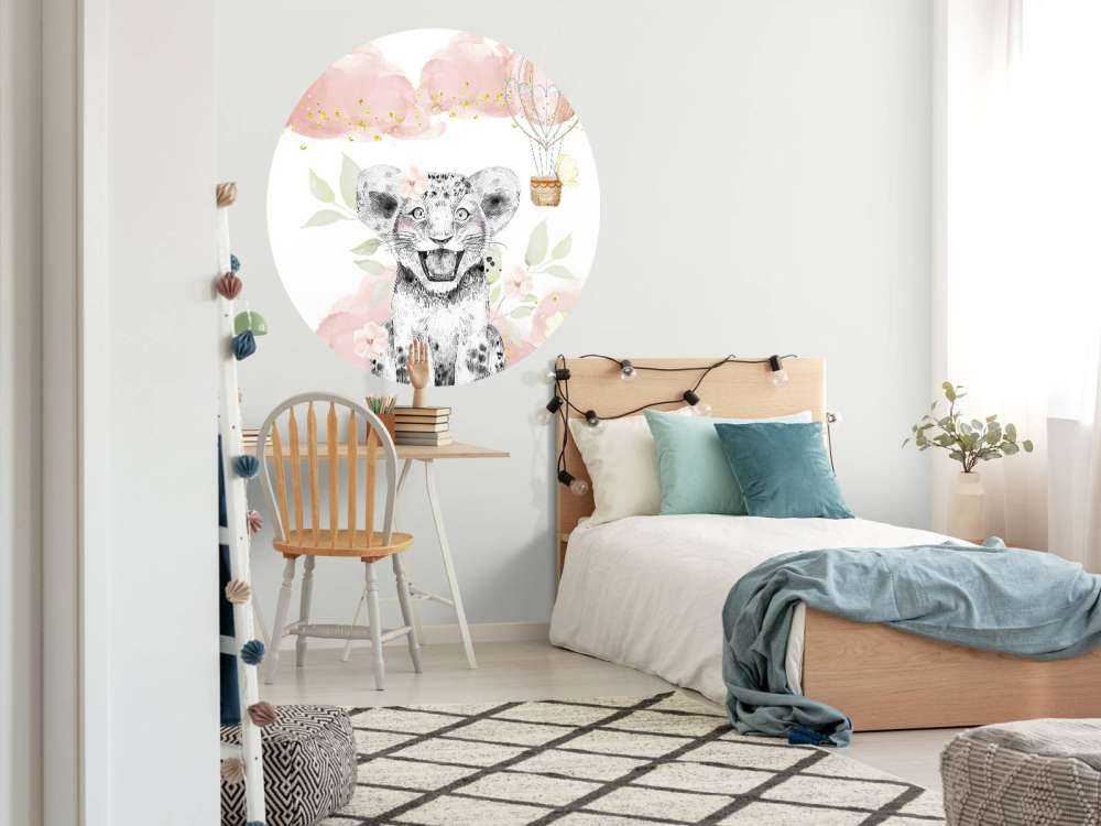 Joyful lion cub and balloon